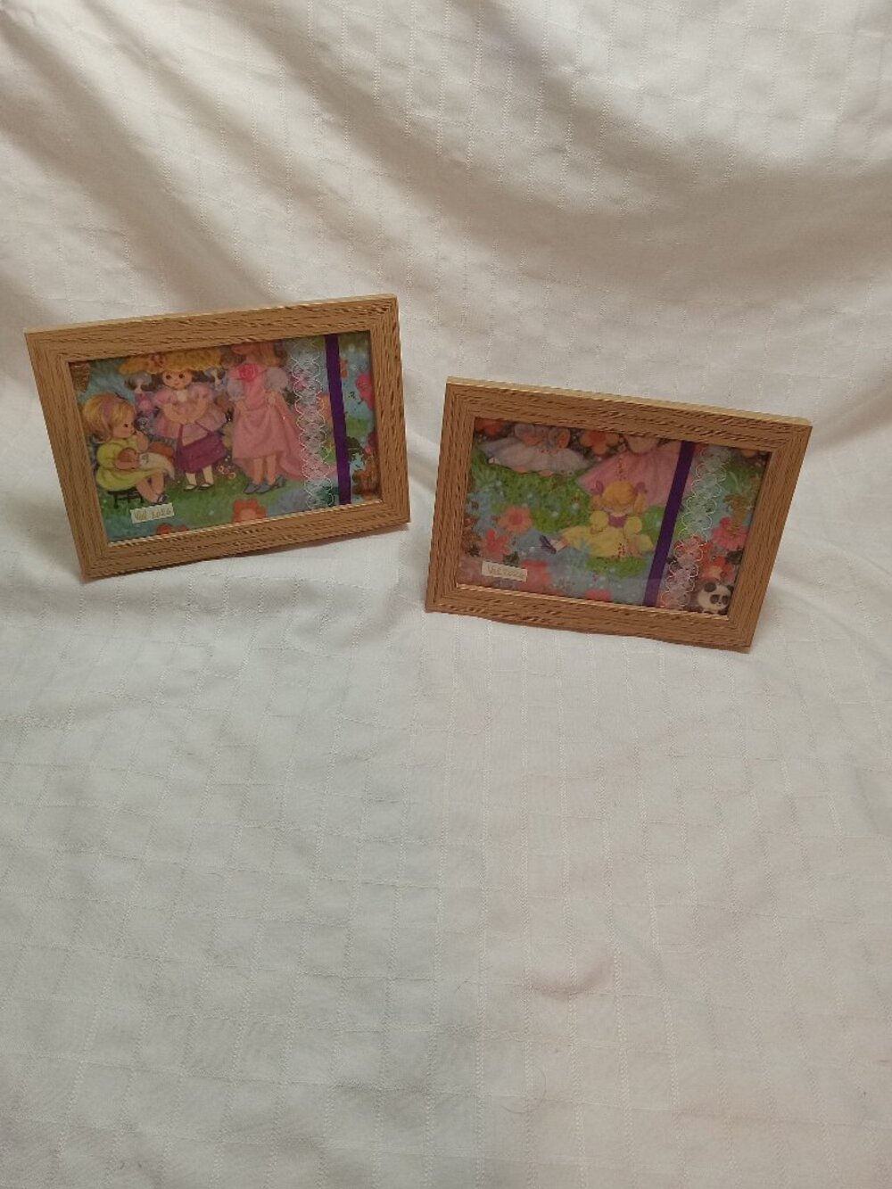 A set of delicate picture frames for a baby's room with vintage wrapping paper
